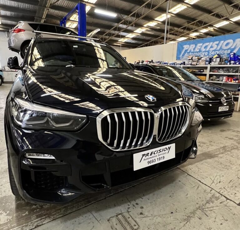 Precision Automotive independent BMW specialist mechanic diagnosing a 5 Series sedan at our Dunning Avenue workshop in Rosebery.